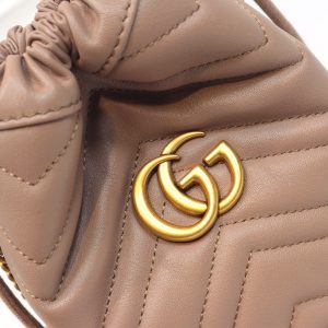 GUCCI GG Marmont Mini Bucket Bag. Authentic quality luxury bag crafted in genuine leather comes with authenticity card, dust bag and gift bag. Unleash the Vibrant Charm of Timeless Elegance. Introducing the latest addition to the GG Marmont collection: the mini bucket bag in stunning vibrant tones, meticulously crafted from Matelassé leather. This exquisite piece draws inspiration from a timeless '70s design, symbolizing the essence of the House. The iconic Double G emblem adorns the front of this accessory, further elevating its allure. With its convenient chain strap and elegant drawstring closure, this versatile bag effortlessly transitions from a shoulder bag to a crossbody one. Experience the epitome of style and functionality with this remarkable creation. - KRIS + KIKO GUCCI GG Marmont Mini Bucket Bag. Original Quality Bag including gift box, literature, dust bag, authenticity card. The world of GG Marmont expands with the introduction of a mini bucket bag shape crafted from Matelassé leather in vibrant tones. Inspired by an archival design from the '70s, a hallmark era of the House, the Double G decorates the front of this accessory. Featuring a chain strap and drawstring closure the versatile shape can be worn as shoulder and as a crossbody bag.