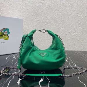 PRADA Re-Edition 2006 Nylon Hobo. Authentic quality luxury bag crafted in genuine leather comes with authenticity card, dust bag and gift bag. Classic Silhouette, Modern Functionality, Unforgettable Style. Crafted from the renowned and recognizable nylon, a fabric emblematic of the brand, this shoulder bag effortlessly melds a timeless design with contemporary and practical elements. Enhancing its appeal are the detachable chain shoulder strap and the Re-Edition leather keyring, further elevating this accessory. - KRIS + KIKO PRADA Re-Edition 2006 Nylon Hobo. Authentic quality luxury bag crafted in genuine leather comes with authenticity card, dust bag and gift bag. Classic Silhouette, Modern Functionality, Unforgettable Style. Crafted from the renowned and recognizable nylon, a fabric emblematic of the brand, this shoulder bag effortlessly melds a timeless design with contemporary and practical elements. Enhancing its appeal are the detachable chain shoulder strap and the Re-Edition leather keyring, further elevating this accessory.