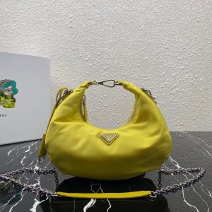 PRADA Re-Edition 2006 Nylon Hobo. Authentic quality luxury bag crafted in genuine leather comes with authenticity card, dust bag and gift bag. Classic Silhouette, Modern Functionality, Unforgettable Style. Crafted from the renowned and recognizable nylon, a fabric emblematic of the brand, this shoulder bag effortlessly melds a timeless design with contemporary and practical elements. Enhancing its appeal are the detachable chain shoulder strap and the Re-Edition leather keyring, further elevating this accessory. - KRIS + KIKO PRADA Re-Edition 2006 Nylon Hobo. Original Quality Bag including gift box, literature, dust bag, authenticity card. Made of iconic nylon, a distinctive fabric of the brand, this shoulder bag combines a classic silhouette and modern, functional details. The accessory is enriched by the detachable chain shoulder strap and the Re-Edition leather keyring.