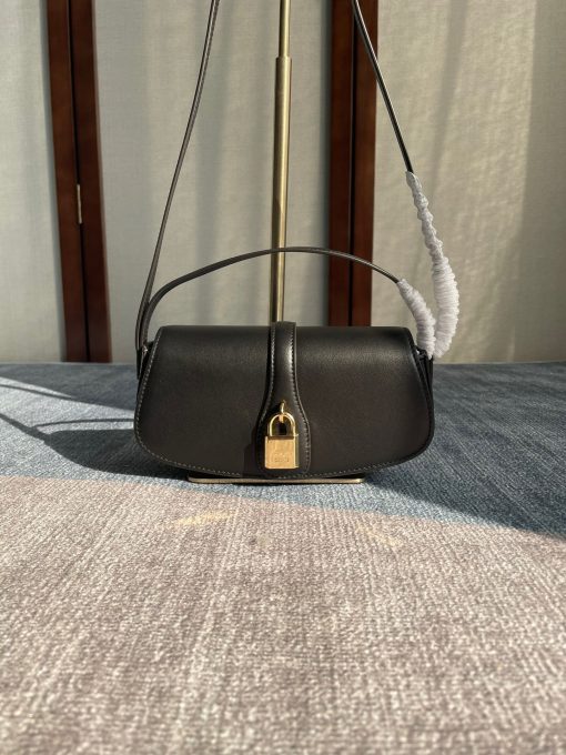 CELINE Clutch On Strap. Authentic quality luxury bag crafted in genuine leather comes with authenticity card, dust bag and gift bag. Impeccably Minimalistic, Captivatingly Chic. Celine has truly outdone themselves with this exquisite small bag, which showcases their exceptional design skills in a minimalistic edition. The standout feature of this bag is the remarkable leather strap that elegantly connects to the ornamental lock, boasting a beautifully large and shimmering gold hardware. This captivating lock will undoubtedly steal all the attention. To cater to various carrying preferences, the bag is equipped with a convenient short-handle for hand-carry, while also providing a long leather strap for shoulder carry. The slender and delicate appearance of the straps adds a touch of femininity to this delightful creation.