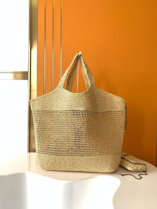 SAINT LAURENT ICare In Raffia. Authentic quality luxury bag comes with authenticity card, dust bag and gift bag. Handcrafted elegance with versatile style. Introducing the Maxi Shopping Bag, exquisitely crafted from hand-embroidered natural raffia. This exceptional piece showcases the finest savoir-faire and specialized craftsmanship. Adorned with an oversized, sculptural Cassandre, the bag features an inner chain that can be used to adjust the sides for versatile styling. Additionally, it comes with a removable raffia sunglasses case, elegantly attached by a long chain, blending functionality with high fashion.