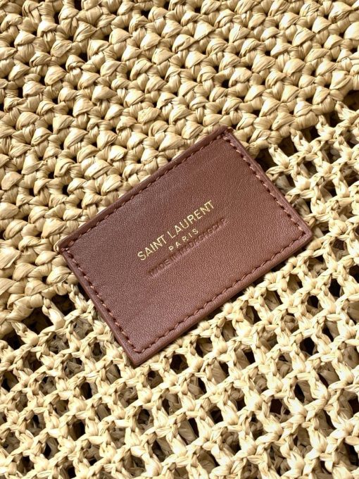 SAINT LAURENT ICare In Raffia. Authentic quality luxury bag comes with authenticity card, dust bag and gift bag. Handcrafted elegance with versatile style. Introducing the Maxi Shopping Bag, exquisitely crafted from hand-embroidered natural raffia. This exceptional piece showcases the finest savoir-faire and specialized craftsmanship. Adorned with an oversized, sculptural Cassandre, the bag features an inner chain that can be used to adjust the sides for versatile styling. Additionally, it comes with a removable raffia sunglasses case, elegantly attached by a long chain, blending functionality with high fashion.