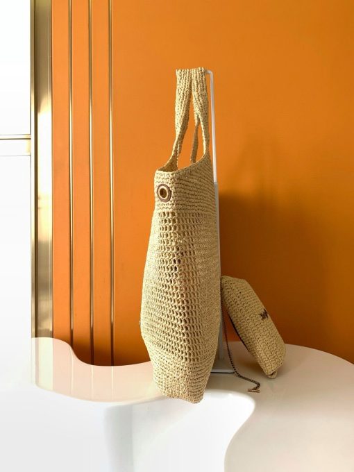 SAINT LAURENT ICare In Raffia. Authentic quality luxury bag comes with authenticity card, dust bag and gift bag. Handcrafted elegance with versatile style. Introducing the Maxi Shopping Bag, exquisitely crafted from hand-embroidered natural raffia. This exceptional piece showcases the finest savoir-faire and specialized craftsmanship. Adorned with an oversized, sculptural Cassandre, the bag features an inner chain that can be used to adjust the sides for versatile styling. Additionally, it comes with a removable raffia sunglasses case, elegantly attached by a long chain, blending functionality with high fashion.