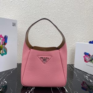 PRADA Logo Plaque Tote Bag. Authentic quality luxury bag crafted in genuine leather comes with authenticity card, dust bag and gift bag. A Masterpiece of Organization, Elegance, and Versatility. Introducing the generously sized shopper tote by PRADA, featuring three internal compartments for impeccable organization. With its timeless and adaptable design, Prada has perfected the ultimate bag that fulfills all your needs. Crafted from luxurious leather, this tote bag showcases an elegant logo patch, complemented by a sleek silver-tone logo plaque at the front. Inside, you'll find an internal signature triangle logo patch, adding an extra touch of sophistication. This exquisite tote is the ideal addition to your expanding collection. - KRIS + KIKO PRADA Logo Plaque Tote Bag. Original Quality Bag including gift box, literature, dust bag, authenticity card. This spacious shopper tote from PRADA boasts three internal compartments to ensure organization. Classic in design and as versatile as it gets, Prada knows how to design the bag that tote-ally fits all your needs and it comes in the form of this leather logo patch tote bag. This tote bag is detailed with a silver-tone logo plaque to the front and an internal signature triangle logo patch which give it an extra refined touch. The perfect addition to your ever-growing collection.