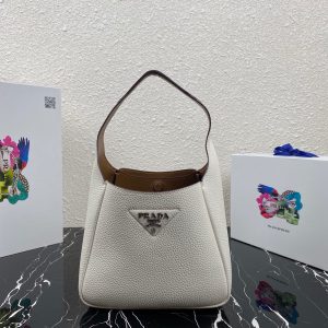 PRADA Logo Plaque Tote Bag. Authentic quality luxury bag crafted in genuine leather comes with authenticity card, dust bag and gift bag. A Masterpiece of Organization, Elegance, and Versatility. Introducing the generously sized shopper tote by PRADA, featuring three internal compartments for impeccable organization. With its timeless and adaptable design, Prada has perfected the ultimate bag that fulfills all your needs. Crafted from luxurious leather, this tote bag showcases an elegant logo patch, complemented by a sleek silver-tone logo plaque at the front. Inside, you'll find an internal signature triangle logo patch, adding an extra touch of sophistication. This exquisite tote is the ideal addition to your expanding collection. - KRIS + KIKO PRADA Logo Plaque Tote Bag. Original Quality Bag including gift box, literature, dust bag, authenticity card. This spacious shopper tote from PRADA boasts three internal compartments to ensure organization. Classic in design and as versatile as it gets, Prada knows how to design the bag that tote-ally fits all your needs and it comes in the form of this leather logo patch tote bag. This tote bag is detailed with a silver-tone logo plaque to the front and an internal signature triangle logo patch which give it an extra refined touch. The perfect addition to your ever-growing collection.