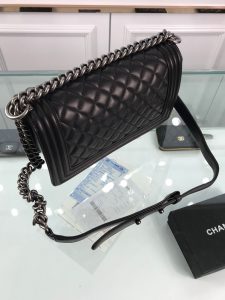 CHANEL Boy Quilted Leather Flap Bag. Authentic quality luxury bag crafted in genuine leather comes with authenticity card, dust bag and gift bag. Unveil Elegance: Elevate Your Style with CHANEL's Iconic Quilted Flap Bag. Elegantly designed, this exceptional CHANEL Boy quilted flap bag boasts a striking chain-link strap with a comfortable shoulder pad, a distinctive CC Boy logo push-lock closure, and exquisite antiqued hardware accents. Opening the push-lock closure reveals a luxurious black fabric-lined interior, complete with convenient side zip and slip pockets, perfect for securely organizing one's daily necessities. - KRIS + KIKO CHANEL Boy Quilted Leather Flap Bag. Original Quality Bag including gift box, literature, dust bag, authenticity card. This stand-out, enviable CHANEL Boy quilted flap bag features a chunky chain-link strap with shoulder pad, CC Boy logo push-lock closure, and antiqued hardware accents. Its push-lock closure opens to a black fabric-lined interior with side zip and slip pockets to secure daily essentials.