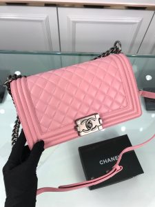 CHANEL Boy Quilted Leather Flap Bag. Authentic quality luxury bag crafted in genuine leather comes with authenticity card, dust bag and gift bag. Unveil Elegance: Elevate Your Style with CHANEL's Iconic Quilted Flap Bag. Elegantly designed, this exceptional CHANEL Boy quilted flap bag boasts a striking chain-link strap with a comfortable shoulder pad, a distinctive CC Boy logo push-lock closure, and exquisite antiqued hardware accents. Opening the push-lock closure reveals a luxurious black fabric-lined interior, complete with convenient side zip and slip pockets, perfect for securely organizing one's daily necessities. - KRIS + KIKO CHANEL Boy Quilted Leather Flap Bag. Original Quality Bag including gift box, literature, dust bag, authenticity card. This stand-out, enviable CHANEL Boy quilted flap bag features a chunky chain-link strap with shoulder pad, CC Boy logo push-lock closure, and antiqued hardware accents. Its push-lock closure opens to a black fabric-lined interior with side zip and slip pockets to secure daily essentials.