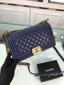 CHANEL Boy Quilted Leather Flap Bag. Authentic quality luxury bag crafted in genuine leather comes with authenticity card, dust bag and gift bag. Unveil Elegance: Elevate Your Style with CHANEL's Iconic Quilted Flap Bag. Elegantly designed, this exceptional CHANEL Boy quilted flap bag boasts a striking chain-link strap with a comfortable shoulder pad, a distinctive CC Boy logo push-lock closure, and exquisite antiqued hardware accents. Opening the push-lock closure reveals a luxurious black fabric-lined interior, complete with convenient side zip and slip pockets, perfect for securely organizing one's daily necessities. - KRIS + KIKO CHANEL Boy Quilted Leather Flap Bag. Original Quality Bag including gift box, literature, dust bag, authenticity card. This stand-out, enviable CHANEL Boy quilted flap bag features a chunky chain-link strap with shoulder pad, CC Boy logo push-lock closure, and antiqued hardware accents. Its push-lock closure opens to a black fabric-lined interior with side zip and slip pockets to secure daily essentials.