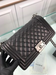 CHANEL Boy Quilted Leather Flap Bag. Authentic quality luxury bag crafted in genuine leather comes with authenticity card, dust bag and gift bag. Unveil Elegance: Elevate Your Style with CHANEL's Iconic Quilted Flap Bag. Elegantly designed, this exceptional CHANEL Boy quilted flap bag boasts a striking chain-link strap with a comfortable shoulder pad, a distinctive CC Boy logo push-lock closure, and exquisite antiqued hardware accents. Opening the push-lock closure reveals a luxurious black fabric-lined interior, complete with convenient side zip and slip pockets, perfect for securely organizing one's daily necessities. - KRIS + KIKO CHANEL Boy Quilted Leather Flap Bag. Original Quality Bag including gift box, literature, dust bag, authenticity card. This stand-out, enviable CHANEL Boy quilted flap bag features a chunky chain-link strap with shoulder pad, CC Boy logo push-lock closure, and antiqued hardware accents. Its push-lock closure opens to a black fabric-lined interior with side zip and slip pockets to secure daily essentials.