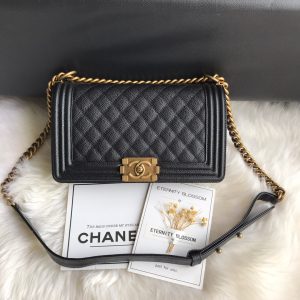 CHANEL Boy Quilted Leather Flap Bag. Authentic quality luxury bag crafted in genuine leather comes with authenticity card, dust bag and gift bag. Unveil Elegance: Elevate Your Style with CHANEL's Iconic Quilted Flap Bag. Elegantly designed, this exceptional CHANEL Boy quilted flap bag boasts a striking chain-link strap with a comfortable shoulder pad, a distinctive CC Boy logo push-lock closure, and exquisite antiqued hardware accents. Opening the push-lock closure reveals a luxurious black fabric-lined interior, complete with convenient side zip and slip pockets, perfect for securely organizing one's daily necessities. - KRIS + KIKO CHANEL Boy Quilted Leather Flap Bag. Original Quality Bag including gift box, literature, dust bag, authenticity card. This stand-out, enviable CHANEL Boy quilted flap bag features a chunky chain-link strap with shoulder pad, CC Boy logo push-lock closure, and antiqued hardware accents. Its push-lock closure opens to a black fabric-lined interior with side zip and slip pockets to secure daily essentials.