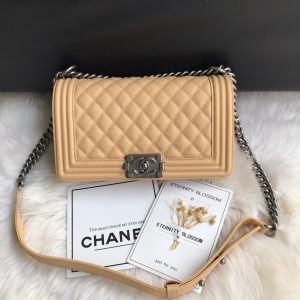 CHANEL Boy Quilted Leather Flap Bag. Authentic quality luxury bag crafted in genuine leather comes with authenticity card, dust bag and gift bag. Unveil Elegance: Elevate Your Style with CHANEL's Iconic Quilted Flap Bag. Elegantly designed, this exceptional CHANEL Boy quilted flap bag boasts a striking chain-link strap with a comfortable shoulder pad, a distinctive CC Boy logo push-lock closure, and exquisite antiqued hardware accents. Opening the push-lock closure reveals a luxurious black fabric-lined interior, complete with convenient side zip and slip pockets, perfect for securely organizing one's daily necessities. - KRIS + KIKO CHANEL Boy Quilted Leather Flap Bag. Original Quality Bag including gift box, literature, dust bag, authenticity card. This stand-out, enviable CHANEL Boy quilted flap bag features a chunky chain-link strap with shoulder pad, CC Boy logo push-lock closure, and antiqued hardware accents. Its push-lock closure opens to a black fabric-lined interior with side zip and slip pockets to secure daily essentials.