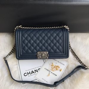 CHANEL Boy Quilted Leather Flap Bag. Authentic quality luxury bag crafted in genuine leather comes with authenticity card, dust bag and gift bag. Unveil Elegance: Elevate Your Style with CHANEL's Iconic Quilted Flap Bag. Elegantly designed, this exceptional CHANEL Boy quilted flap bag boasts a striking chain-link strap with a comfortable shoulder pad, a distinctive CC Boy logo push-lock closure, and exquisite antiqued hardware accents. Opening the push-lock closure reveals a luxurious black fabric-lined interior, complete with convenient side zip and slip pockets, perfect for securely organizing one's daily necessities. - KRIS + KIKO CHANEL Boy Quilted Leather Flap Bag. Original Quality Bag including gift box, literature, dust bag, authenticity card. This stand-out, enviable CHANEL Boy quilted flap bag features a chunky chain-link strap with shoulder pad, CC Boy logo push-lock closure, and antiqued hardware accents. Its push-lock closure opens to a black fabric-lined interior with side zip and slip pockets to secure daily essentials.