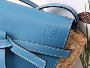 LOEWE Gate Mini Raffia Crossbody Bag. Authentic quality luxury bag crafted in genuine leather comes with authenticity card, dust bag and gift bag. A forever-loved accessory for the style-conscious. Complete your outfit with this delightful woven raffia version of Loewe's popular Gate bag, perfect for the summer season. The petite design showcases a charming flap closure made from calf leather, adorned with a graceful knot detail that wraps over the front. Consider it a timeless investment that you'll cherish for years to come. - KRIS + KIKO LOEWE Gate Mini Raffia Crossbody Bag. Original Quality Bag. Authentic Soft Calfskin and Woven Raffia. LOEWE Sales Box and Dust Bag. Booklet, Authenticity Card, Payment Slip. Finish off your look with this summery woven raffia iteration of Loewe's beloved Gate bag. The mini silhouette features a contrasting flap closure, which has been made from calf leather with an elegant knot detail wrapping over the front. Think of it as the sort of piece that you'll buy now but love forever.