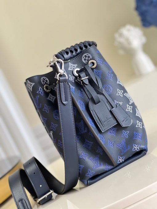 LOUIS VUITTON Muria. Authentic quality luxury bag crafted in genuine leather comes with authenticity card, dust bag and gift bag. A Fashionable Fusion of Colors and Craftsmanship! Introducing the Muria bucket bag, crafted from a refreshing Mahina perforated leather in a unique blend of blue, red, and caramel hues. Each tiny hole intricately hand-dyed, this striking tricolor rendition of the iconic Monogram pattern adds a vibrant flair to the supple calf leather. Completing the ensemble, the bag features a beautifully braided top handle.