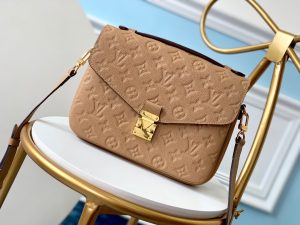 LOUIS VUITTON Pochette Métis Monogram Empreinte Leather. Authentic quality luxury bag crafted in genuine leather comes with authenticity card, dust bag and gift bag. Elegance meets functionality. The epitome of grace and sophistication is embodied in the dainty silhouette of the Pochette Métis. Crafted from supple Monogram empreinte leather, its petite proportions unveil a plethora of practical pockets and compartments. - KRIS + KIKO LOUIS VUITTON Pochette Métis Monogram Empreinte Leather. Original Quality Bag. Gold-metal toned Hardware. LOUIS VUITTON Sales Box and Dust Bag. Booklet, Authenticity Card, Payment Slip. Elegance is personified in the petite shape of the Pochette Métis. Made of supple Monogram empreinte leather, its compact dimensions open up to reveal many useful pockets and compartments.