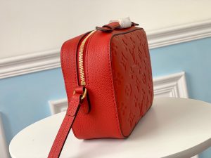 LOUIS VUITTON 'Saintonge' Monogram Empreinte Leather Bag. Authentic quality luxury bag crafted in genuine leather comes with authenticity card, dust bag and gift bag. Embrace effortless elegance. Crafted from luxurious embossed Monogram Empreinte leather, this version of the Saintonge handbag exudes charm with its delightful tassels and opulent golden hardware. Its compact size perfectly accommodates a woman's everyday necessities, effortlessly transitioning from day to evening. Whether elegantly grasped by the supple top handle or gracefully suspended from the adjustable shoulder strap, this exquisite handbag ensures a seamless and stylish transition throughout the day. - KRIS + KIKO LOUIS VUITTON 'Saintonge' Monogram Empreinte Leather Bag. Authentic quality luxury bag crafted in genuine leather comes with authenticity card, dust bag and gift bag. Embrace effortless elegance. Crafted from luxurious embossed Monogram Empreinte leather, this version of the Saintonge handbag exudes charm with its delightful tassels and opulent golden hardware. Its compact size perfectly accommodates a woman's everyday necessities, effortlessly transitioning from day to evening. Whether elegantly grasped by the supple top handle or gracefully suspended from the adjustable shoulder strap, this exquisite handbag ensures a seamless and stylish transition throughout the day.