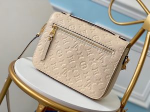 LOUIS VUITTON Pochette Métis Monogram Empreinte Leather. Authentic quality luxury bag crafted in genuine leather comes with authenticity card, dust bag and gift bag. Elegance meets functionality. The epitome of grace and sophistication is embodied in the dainty silhouette of the Pochette Métis. Crafted from supple Monogram empreinte leather, its petite proportions unveil a plethora of practical pockets and compartments. - KRIS + KIKO LOUIS VUITTON Pochette Métis Monogram Empreinte Leather. Original Quality Bag. Gold-metal toned Hardware. LOUIS VUITTON Sales Box and Dust Bag. Booklet, Authenticity Card, Payment Slip. Elegance is personified in the petite shape of the Pochette Métis. Made of supple Monogram empreinte leather, its compact dimensions open up to reveal many useful pockets and compartments.