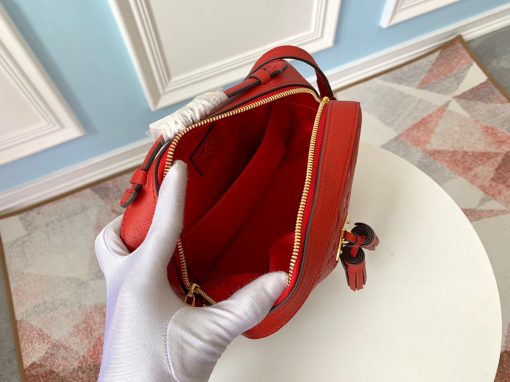 LOUIS VUITTON 'Saintonge' Monogram Empreinte Leather Bag. Authentic quality luxury bag crafted in genuine leather comes with authenticity card, dust bag and gift bag. Embrace effortless elegance. Crafted from luxurious embossed Monogram Empreinte leather, this version of the Saintonge handbag exudes charm with its delightful tassels and opulent golden hardware. Its compact size perfectly accommodates a woman's everyday necessities, effortlessly transitioning from day to evening. Whether elegantly grasped by the supple top handle or gracefully suspended from the adjustable shoulder strap, this exquisite handbag ensures a seamless and stylish transition throughout the day.