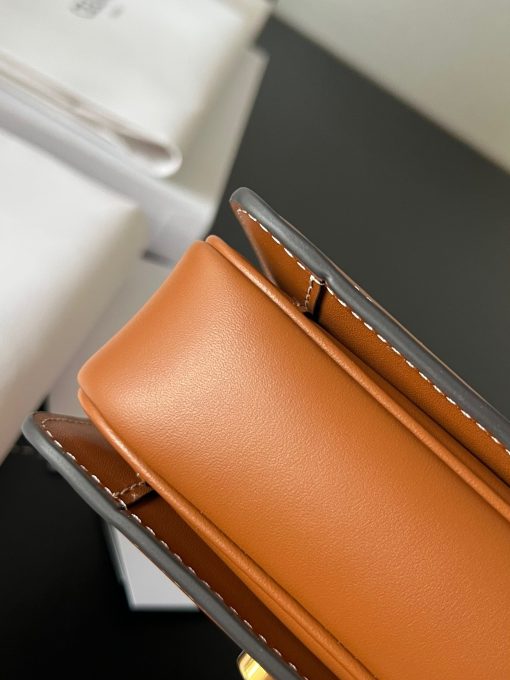 CELINE Teen Triomphe. Authentic quality luxury bag crafted in genuine leather comes with authenticity card, dust bag and gift bag. Where timeless elegance meets fashion-forward sophistication. The original Triomphe, launched by Hedi Slimane in 2018, garnered widespread praise. Since then, this chic handbag has become a favorite amongst celebrities and fashion insiders worldwide. Its sleek leather exterior and understated hardware effortlessly merge style and practicality, beautifully accentuated by Celine's iconic golden Triomphe logo fastener. This exquisite design has captivated the interest of bag collectors and fashion historians alike, thanks to its sophisticated yet uncomplicated aesthetic. The timeless appeal of this classic piece has even inspired a range of spinoffs, solidifying the Triomphe's status as a revered fashion icon.