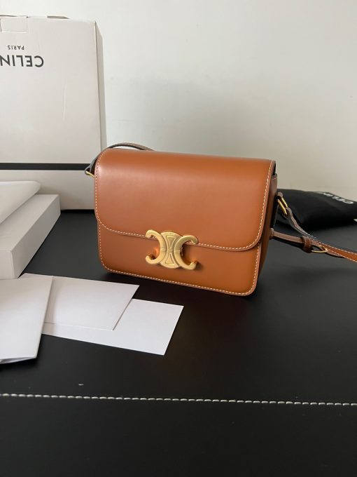 CELINE Teen Triomphe. Authentic quality luxury bag crafted in genuine leather comes with authenticity card, dust bag and gift bag. Where timeless elegance meets fashion-forward sophistication. The original Triomphe, launched by Hedi Slimane in 2018, garnered widespread praise. Since then, this chic handbag has become a favorite amongst celebrities and fashion insiders worldwide. Its sleek leather exterior and understated hardware effortlessly merge style and practicality, beautifully accentuated by Celine's iconic golden Triomphe logo fastener. This exquisite design has captivated the interest of bag collectors and fashion historians alike, thanks to its sophisticated yet uncomplicated aesthetic. The timeless appeal of this classic piece has even inspired a range of spinoffs, solidifying the Triomphe's status as a revered fashion icon.