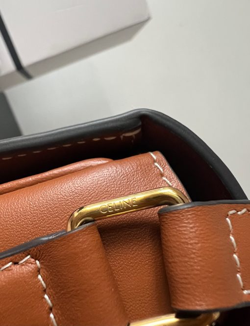CELINE Teen Triomphe. Authentic quality luxury bag crafted in genuine leather comes with authenticity card, dust bag and gift bag. Where timeless elegance meets fashion-forward sophistication. The original Triomphe, launched by Hedi Slimane in 2018, garnered widespread praise. Since then, this chic handbag has become a favorite amongst celebrities and fashion insiders worldwide. Its sleek leather exterior and understated hardware effortlessly merge style and practicality, beautifully accentuated by Celine's iconic golden Triomphe logo fastener. This exquisite design has captivated the interest of bag collectors and fashion historians alike, thanks to its sophisticated yet uncomplicated aesthetic. The timeless appeal of this classic piece has even inspired a range of spinoffs, solidifying the Triomphe's status as a revered fashion icon.