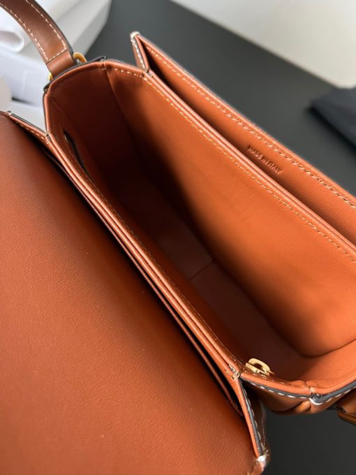CELINE Teen Triomphe. Authentic quality luxury bag crafted in genuine leather comes with authenticity card, dust bag and gift bag. Where timeless elegance meets fashion-forward sophistication. The original Triomphe, launched by Hedi Slimane in 2018, garnered widespread praise. Since then, this chic handbag has become a favorite amongst celebrities and fashion insiders worldwide. Its sleek leather exterior and understated hardware effortlessly merge style and practicality, beautifully accentuated by Celine's iconic golden Triomphe logo fastener. This exquisite design has captivated the interest of bag collectors and fashion historians alike, thanks to its sophisticated yet uncomplicated aesthetic. The timeless appeal of this classic piece has even inspired a range of spinoffs, solidifying the Triomphe's status as a revered fashion icon.