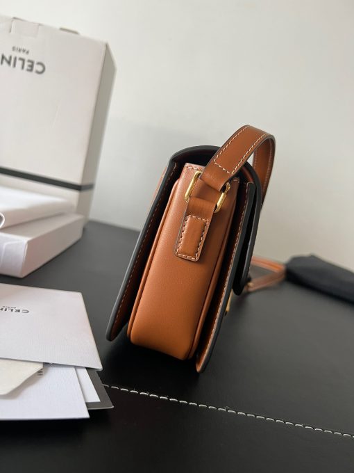 CELINE Teen Triomphe. Authentic quality luxury bag crafted in genuine leather comes with authenticity card, dust bag and gift bag. Where timeless elegance meets fashion-forward sophistication. The original Triomphe, launched by Hedi Slimane in 2018, garnered widespread praise. Since then, this chic handbag has become a favorite amongst celebrities and fashion insiders worldwide. Its sleek leather exterior and understated hardware effortlessly merge style and practicality, beautifully accentuated by Celine's iconic golden Triomphe logo fastener. This exquisite design has captivated the interest of bag collectors and fashion historians alike, thanks to its sophisticated yet uncomplicated aesthetic. The timeless appeal of this classic piece has even inspired a range of spinoffs, solidifying the Triomphe's status as a revered fashion icon.