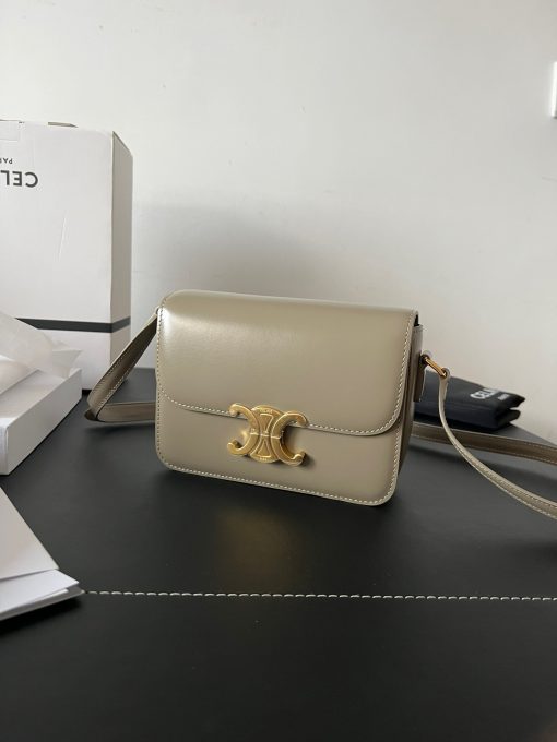 CELINE Teen Triomphe. Authentic quality luxury bag crafted in genuine leather comes with authenticity card, dust bag and gift bag. Where timeless elegance meets fashion-forward sophistication. The original Triomphe, launched by Hedi Slimane in 2018, garnered widespread praise. Since then, this chic handbag has become a favorite amongst celebrities and fashion insiders worldwide. Its sleek leather exterior and understated hardware effortlessly merge style and practicality, beautifully accentuated by Celine's iconic golden Triomphe logo fastener. This exquisite design has captivated the interest of bag collectors and fashion historians alike, thanks to its sophisticated yet uncomplicated aesthetic. The timeless appeal of this classic piece has even inspired a range of spinoffs, solidifying the Triomphe's status as a revered fashion icon.