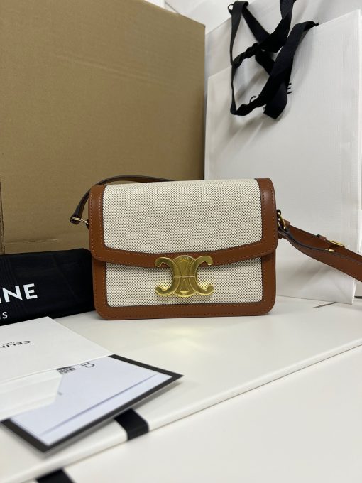 CELINE Teen Triomphe. Authentic quality luxury bag crafted in genuine leather comes with authenticity card, dust bag and gift bag. Where timeless elegance meets fashion-forward sophistication. The original Triomphe, launched by Hedi Slimane in 2018, garnered widespread praise. Since then, this chic handbag has become a favorite amongst celebrities and fashion insiders worldwide. Its sleek leather exterior and understated hardware effortlessly merge style and practicality, beautifully accentuated by Celine's iconic golden Triomphe logo fastener. This exquisite design has captivated the interest of bag collectors and fashion historians alike, thanks to its sophisticated yet uncomplicated aesthetic. The timeless appeal of this classic piece has even inspired a range of spinoffs, solidifying the Triomphe's status as a revered fashion icon.