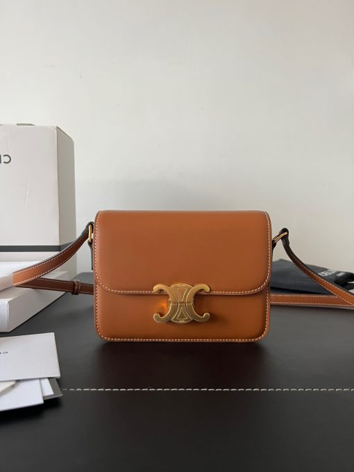 CELINE Teen Triomphe. Authentic quality luxury bag crafted in genuine leather comes with authenticity card, dust bag and gift bag. Where timeless elegance meets fashion-forward sophistication. The original Triomphe, launched by Hedi Slimane in 2018, garnered widespread praise. Since then, this chic handbag has become a favorite amongst celebrities and fashion insiders worldwide. Its sleek leather exterior and understated hardware effortlessly merge style and practicality, beautifully accentuated by Celine's iconic golden Triomphe logo fastener. This exquisite design has captivated the interest of bag collectors and fashion historians alike, thanks to its sophisticated yet uncomplicated aesthetic. The timeless appeal of this classic piece has even inspired a range of spinoffs, solidifying the Triomphe's status as a revered fashion icon.