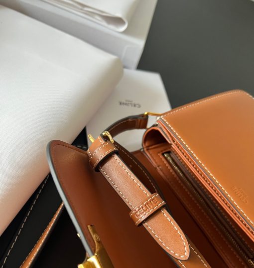 CELINE Teen Triomphe. Authentic quality luxury bag crafted in genuine leather comes with authenticity card, dust bag and gift bag. Where timeless elegance meets fashion-forward sophistication. The original Triomphe, launched by Hedi Slimane in 2018, garnered widespread praise. Since then, this chic handbag has become a favorite amongst celebrities and fashion insiders worldwide. Its sleek leather exterior and understated hardware effortlessly merge style and practicality, beautifully accentuated by Celine's iconic golden Triomphe logo fastener. This exquisite design has captivated the interest of bag collectors and fashion historians alike, thanks to its sophisticated yet uncomplicated aesthetic. The timeless appeal of this classic piece has even inspired a range of spinoffs, solidifying the Triomphe's status as a revered fashion icon.