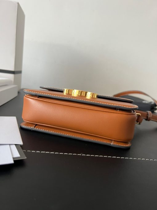 CELINE Teen Triomphe. Authentic quality luxury bag crafted in genuine leather comes with authenticity card, dust bag and gift bag. Where timeless elegance meets fashion-forward sophistication. The original Triomphe, launched by Hedi Slimane in 2018, garnered widespread praise. Since then, this chic handbag has become a favorite amongst celebrities and fashion insiders worldwide. Its sleek leather exterior and understated hardware effortlessly merge style and practicality, beautifully accentuated by Celine's iconic golden Triomphe logo fastener. This exquisite design has captivated the interest of bag collectors and fashion historians alike, thanks to its sophisticated yet uncomplicated aesthetic. The timeless appeal of this classic piece has even inspired a range of spinoffs, solidifying the Triomphe's status as a revered fashion icon.