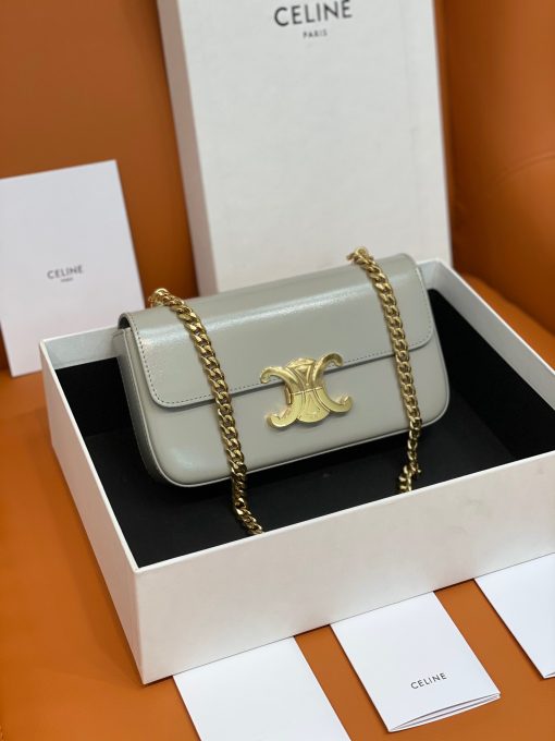 CELINE Chain Shoulder Bag Triomphe In Shiny Calfskin. Authentic quality luxury bag crafted in genuine leather comes with authenticity card, dust bag and gift bag. Effortlessly chic: your perfect companion for everyday elegance. Introducing an exquisite and versatile handbag designed for daily use - the Celine Chain Bag. With its clean and elegant silhouette, this bag is enhanced by a front flap adorned with a stunning Triomphe Metallic Closure. Crafted with utmost attention to detail, it is available in two luxurious materials: Canvas or Calfskin Leather. For added convenience, this bag comes with a drop chain, allowing you to effortlessly carry it as a shoulder or cross body bag. Whether you're attending an evening event or a formal gathering, the Celine Chain Bag will gracefully accompany you. Upon opening the flap, you will discover a spacious main compartment and a handy flat pocket, providing ample storage for your necessities.