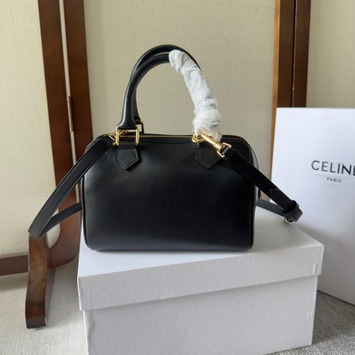 CELINE Small Boston Cuir Triomphe. Authentic quality luxury bag crafted in genuine leather comes with authenticity card, dust bag and gift bag. Style meets sophistication with this timeless bag. This is a classic accessory which is perfect for both day and night. It is made out of smooth calfskin leather with a stitched monogram pattern that creates an elegant, modern look. The bag features a removable and adjustable shoulder strap, a top handle for carrying, and a zipped closure. It also has a main spacious compartment, and one inner flat pocket. It has a small and compact size, perfect for days when you don't want to carry too much. The timeless design will never go out of style, and you'll be sure to feel confident and stylish with this bag on your arm.