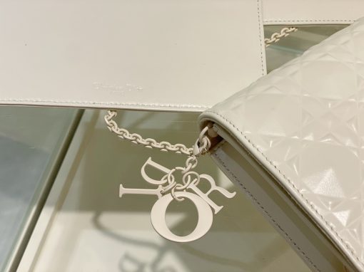 DIOR Lady Dior Pouch. Authentic quality luxury bag crafted in genuine leather comes with authenticity card, dust bag and gift bag. Embrace timeless elegance! The exquisite Lady Dior pouch, handcrafted with the finest calfskin, is easily recognized by its elegant Cannage topstitching embellished with a beautiful Diamond motif, along with a delightful detachable 'D.I.O.R.' charm. This extraordinary accessory offers versatility as it can be worn with or without its chain strap, and it incorporates two detachable components - a practical card holder and a convenient zipped pouch. Each of these elements can be carried individually for added convenience. Adorned with the iconic House motif presented in a striking graphic design, this pouch is sure to make a statement and effortlessly complements other pieces from the same collection.