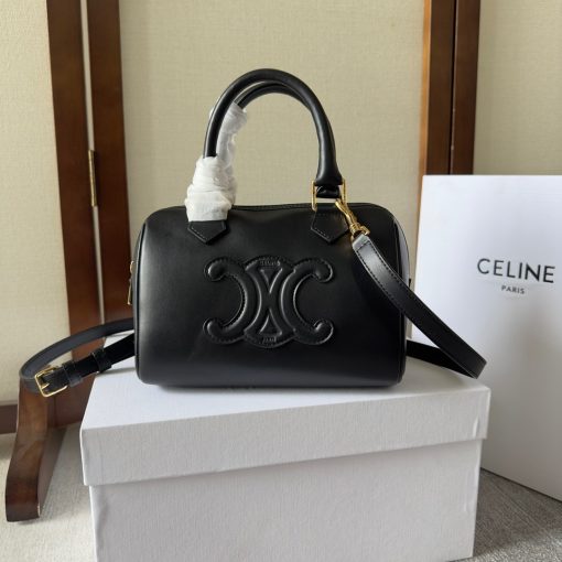 CELINE Small Boston Cuir Triomphe. Authentic quality luxury bag crafted in genuine leather comes with authenticity card, dust bag and gift bag. Style meets sophistication with this timeless bag. This is a classic accessory which is perfect for both day and night. It is made out of smooth calfskin leather with a stitched monogram pattern that creates an elegant, modern look. The bag features a removable and adjustable shoulder strap, a top handle for carrying, and a zipped closure. It also has a main spacious compartment, and one inner flat pocket. It has a small and compact size, perfect for days when you don't want to carry too much. The timeless design will never go out of style, and you'll be sure to feel confident and stylish with this bag on your arm.