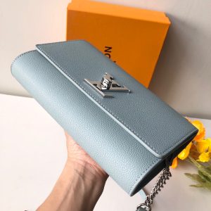 LOUIS VUITTON Lockme Clutch. Authentic quality luxury bag crafted in genuine leather comes with authenticity card, dust bag and gift bag. Unlock the Elegance. Your Day-to-Evening Statement. The Lockme Clutch is a truly eye-catching bag that seamlessly transitions from day to evening. It features the iconic LV turn lock and a luxurious leather top handle, allowing for effortless clutch carry. What sets this bag apart is its clever strap, which can be easily adjusted with press studs to achieve the perfect length for shoulder or cross-body carry. To add a touch of elegance for special evening occasions, a delicate chain is delicately attached to the end of the strap. - KRIS + KIKO LOUIS VUITTON Lockme Clutch. Original Quality Bag including gift box, literature, dust bag, authenticity card. With its iconic LV turn lock and leather top handle for clutch carry, the Lockme Clutch is a striking day-to-evening bag. It boasts a clever strap with press studs to easily adjust the length for shoulder or cross-body carry. The small chain at the end of the strap brings a precious touch for evening occasions.
