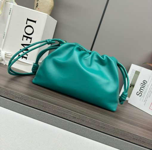 LOEWE Medium Flamenco Purse. Authentic quality luxury bag crafted in genuine leather comes with authenticity card, dust bag and gift bag. Elegant Sophistication. Meet the Flamenco Purse – where timeless style meets modern elegance. Defined by its beautifully ruched design and signature side knots, this medium-sized bag is crafted from soft, supple nappa lambskin. It's the perfect blend of luxurious texture and sophisticated detailing, making it an essential accessory for any wardrobe.
