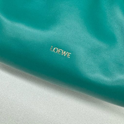 LOEWE Medium Flamenco Purse. Authentic quality luxury bag crafted in genuine leather comes with authenticity card, dust bag and gift bag. Elegant Sophistication. Meet the Flamenco Purse – where timeless style meets modern elegance. Defined by its beautifully ruched design and signature side knots, this medium-sized bag is crafted from soft, supple nappa lambskin. It's the perfect blend of luxurious texture and sophisticated detailing, making it an essential accessory for any wardrobe.