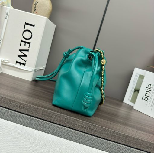 LOEWE Medium Flamenco Purse. Authentic quality luxury bag crafted in genuine leather comes with authenticity card, dust bag and gift bag. Elegant Sophistication. Meet the Flamenco Purse – where timeless style meets modern elegance. Defined by its beautifully ruched design and signature side knots, this medium-sized bag is crafted from soft, supple nappa lambskin. It's the perfect blend of luxurious texture and sophisticated detailing, making it an essential accessory for any wardrobe.