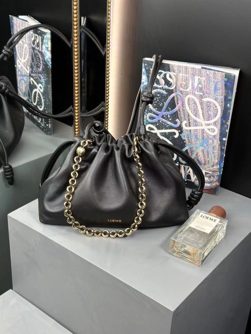 LOEWE Medium Flamenco Purse. Authentic quality luxury bag crafted in genuine leather comes with authenticity card, dust bag and gift bag. Elegant Sophistication. Meet the Flamenco Purse – where timeless style meets modern elegance. Defined by its beautifully ruched design and signature side knots, this medium-sized bag is crafted from soft, supple nappa lambskin. It's the perfect blend of luxurious texture and sophisticated detailing, making it an essential accessory for any wardrobe.
