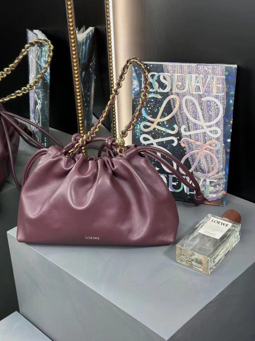 LOEWE Medium Flamenco Purse. Authentic quality luxury bag crafted in genuine leather comes with authenticity card, dust bag and gift bag. Elegant Sophistication. Meet the Flamenco Purse – where timeless style meets modern elegance. Defined by its beautifully ruched design and signature side knots, this medium-sized bag is crafted from soft, supple nappa lambskin. It's the perfect blend of luxurious texture and sophisticated detailing, making it an essential accessory for any wardrobe.