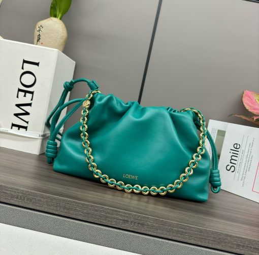 LOEWE Medium Flamenco Purse. Authentic quality luxury bag crafted in genuine leather comes with authenticity card, dust bag and gift bag. Elegant Sophistication. Meet the Flamenco Purse – where timeless style meets modern elegance. Defined by its beautifully ruched design and signature side knots, this medium-sized bag is crafted from soft, supple nappa lambskin. It's the perfect blend of luxurious texture and sophisticated detailing, making it an essential accessory for any wardrobe.