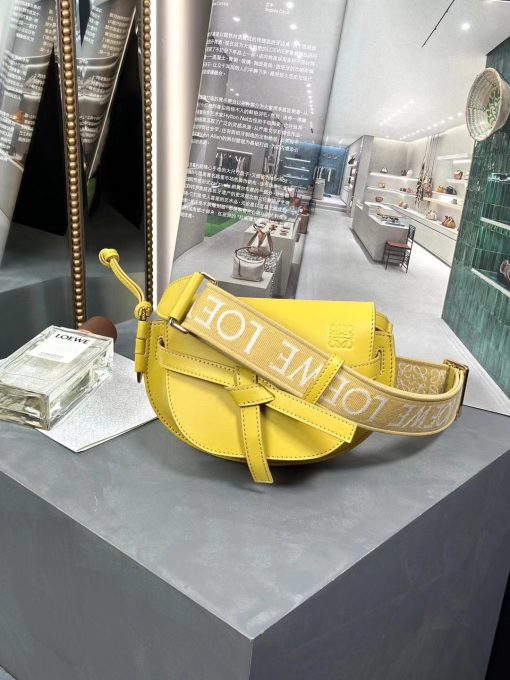 LOEWE Mini Gate Dual Bag. Authentic quality luxury bag crafted in genuine leather comes with authenticity card, dust bag and gift bag. Discover the Art of Leather: Elevate your Style. Exquisitely designed with utmost precision, the Mini Gate Dual showcases LOEWE's unparalleled expertise in leatherwork, enveloped in supple calfskin. Its distinctive features include a meticulously saddle-stitched knotted leather strap and a side-latched metal pin, from which the bag derives its name. Moreover, this miniature rendition is equipped with a removable shoulder strap, also rendered in calfskin, embellished with a repeated LOEWE pattern crafted in jacquard.