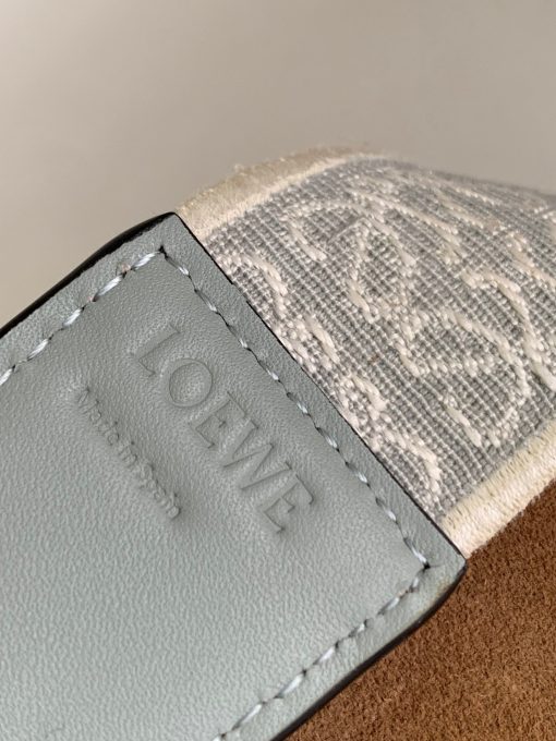 LOEWE Mini Gate Dual Bag. Authentic quality luxury bag crafted in genuine leather comes with authenticity card, dust bag and gift bag. Discover the Art of Leather: Elevate your Style. Exquisitely designed with utmost precision, the Mini Gate Dual showcases LOEWE's unparalleled expertise in leatherwork, enveloped in supple calfskin. Its distinctive features include a meticulously saddle-stitched knotted leather strap and a side-latched metal pin, from which the bag derives its name. Moreover, this miniature rendition is equipped with a removable shoulder strap, also rendered in calfskin, embellished with a repeated LOEWE pattern crafted in jacquard.