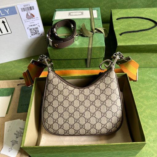 GUCCI Attache Small Shoulder Bag.  Authentic quality luxury bag crafted in genuine leather comes with authenticity card, dust bag and gift bag. Embrace timeless elegance with Gucci Love Parade - where Hollywood glamour and vintage charm unite. *ucci Love Parade pays homage to the enduring allure of Hollywood glamour by incorporating classic elements from the House's rich archives. The accessory, characterized by its elegant crescent moon shape, is adorned with a distinctive G shaped hook closure, adding to its unique charm. Crafted from luxurious materials and featuring heritage hardware, this exquisite design exudes a refined and timeless aesthetic, reminiscent of vintage beauty.