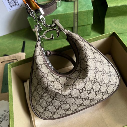 GUCCI Attache Small Shoulder Bag.  Authentic quality luxury bag crafted in genuine leather comes with authenticity card, dust bag and gift bag. Embrace timeless elegance with Gucci Love Parade - where Hollywood glamour and vintage charm unite. *ucci Love Parade pays homage to the enduring allure of Hollywood glamour by incorporating classic elements from the House's rich archives. The accessory, characterized by its elegant crescent moon shape, is adorned with a distinctive G shaped hook closure, adding to its unique charm. Crafted from luxurious materials and featuring heritage hardware, this exquisite design exudes a refined and timeless aesthetic, reminiscent of vintage beauty.