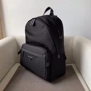 PRADA Black Logo Plaque Nylon and Saffiano Leather Backpack. Authentic quality luxury bag crafted in genuine leather comes with authenticity card, dust bag and gift bag. Practicality meets style, and carrying everything becomes effortlessly chic. Practicality is of utmost importance, while style is also highly valued. This backpack from Prada beautifully combines both aspects, featuring intricate details such as the brand's iconic enameled triangle logo plaque on the front that adds an extra touch of sophistication. It is the ideal choice for those occasions when you need to carry all your essentials and more. Truly the best of both worlds. - KRIS + KIKO PRADA Black Logo Plaque Nylon and Saffiano Leather Backpack. Original Quality Bag including gift box, literature, dust bag, authenticity card. Practicality is key but style is always appreciated, too. Detailed with the brand's signature enameled triangle logo plaque to the front for an extra refined touch, this backpack from Prada is the perfect go-to for whenever you need to carry everything but the kitchen sink. Best of both worlds.