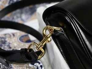 DIOR Small Bobby Bag. Authentic quality luxury bag crafted in genuine leather comes with authenticity card, dust bag and gift bag. Functionality Meets Elegance in Perfect Harmony. Maria Grazia Chiuri has introduced a new addition to the prestigious French fashion house's collection of iconic bags: the Dior Bobby. This stylish bag pays tribute to the owner's beloved pet pooch and showcases a new silhouette that resembles the D-fence bag, featuring the timeless CD logo. The Dior Bobby is the epitome of functionality and elegance, providing the perfect size for fashionable individuals who want to make a statement. With its practical shoulder strap, this sassy bag is perfectly suited to meet the demands of modern life. Its feminine curves and discreet "30 Montaigne" inscription on the back serve as a gentle nod to the renowned symbolic bag that shares its name. - KRIS + KIKO DIOR Small Bobby Bag. Original Quality Bag, including gift box, literature, dust bag, authenticity card. Maria Grazia Chiuri introduced a new silhouette to the French fashion house’s repertoire of It bags: the Dior Bobby which pays homage to the lovely pooch of the master himself. The Dior Bobby is a rounded flap that is similar to the D-fence bag with the classic CD logo. Got to admit, Bobby offers the best size for a bag that’s meant to be functional, easy to strut around in while looking like a million bucks. The Dior Bobby is a sassy shoulder bag that’s well suited for today’s call for practicality. Its feminine curve and the ‘30 Montaigne’ address on the back, renders a subtle echo of the eponymous symbolic bag.
