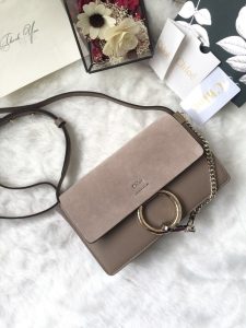 CHLOÉ 'Faye' Small Shoulder Bag. Authentic quality luxury bag crafted in genuine leather comes with authenticity card, dust bag and gift bag. Timeless style meets practicality. Combining functionality with elegance, the new Faye day bag embodies the Maison's nostalgic 70s aura. It boasts a practical magnet closure and spacious compartments, perfect for carrying all of your essentials. The double zips, accompanied by leather pullers, unveil suede gussets that create a delicate textural contrast and lend a feminine charm. Additionally, the bag features the line's distinctive ring loop and a hanging chain that exudes sophisticated hardware and a retro allure. - KRIS + KIKO CHLOÉ 'Faye' Small Shoulder Bag. Original Quality Bag including gift box, care book, dust bag, authenticity card. Functional yet elegant, the new Faye day bag taps into the Maison's 70s spirit while featuring a practical magnet closure and roomy compartments to carry all your belongings. Double zips with leather pullers open to reveal suede gussets for a subtle textural contrast adding a feminine touch. The line’s signature ring loop and hanging chain bring elegant hardware and retro appeal.